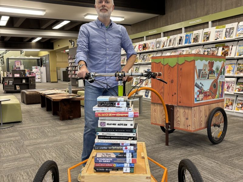 Anthony Halstead demonstrates banned books. Submitted photo