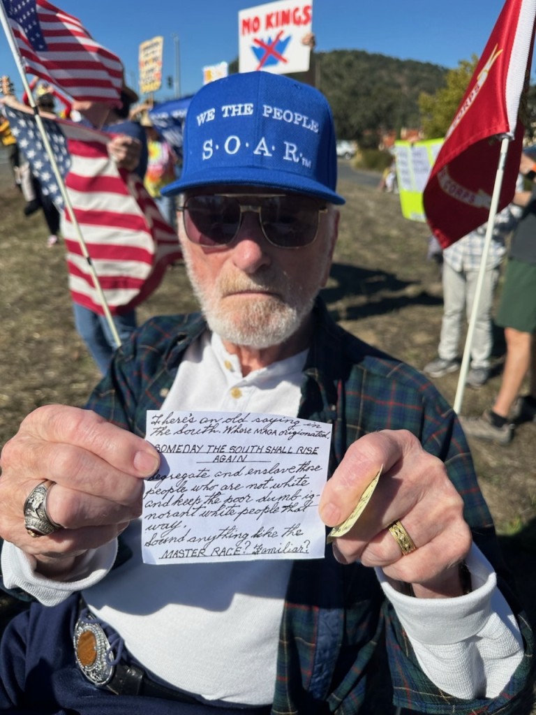 Veteran Richard Ethridge shared a handwritten note that communicated his perspective on parallels with desegregation and MAGA at No Kings 2 in Yountville. Lisa Adams Walter photo