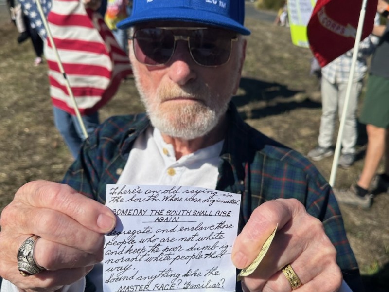 Veteran Richard Ethridge shared a handwritten note that communicated his perspective on parallels with desegregation and MAGA at No Kings 2 in Yountville. Lisa Adams Walter photo
