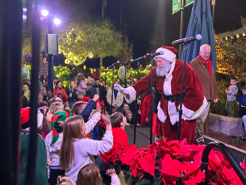 Santa high-fived children as he arrived in Yountville, and continued connecting with the crowd while on stage at the tree lighting. Lisa Adams Walter photo