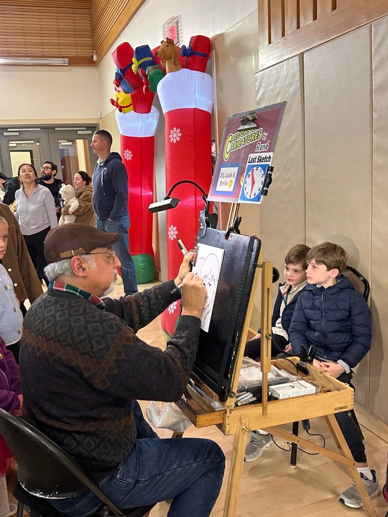 Children posed for cartoon caricatures by René at the Yountville Town and Tree Lighting. Lisa Adams Walter photo
