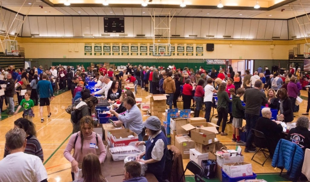 Operation With Love From Home volunteers assemble care packages at a past event. Operation With Love From Home photo