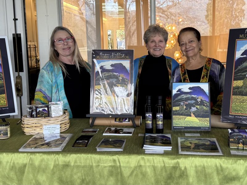Heather Hamilton, Jessel Miller and Nouria Harris stand with copies of this year's poster art at the sold-out Jan. 17 launch of the 2026 Mustard Celebration held at Silverado Resort. Submitted photo