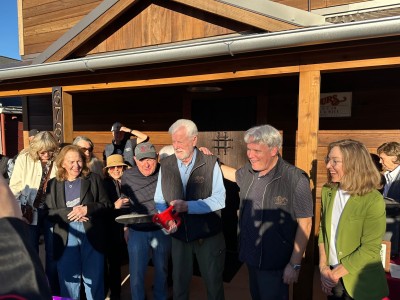 Ren Harris swiftly cut the purple ribbon to officially open Pancha's with partners Paul Frank on his right (in ball cap) and Scott Lewis on his left. Lisa Adams Walter photo
