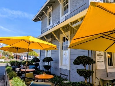 The Yount Room, now open inside the historic Yountville Depot, feautres a newly refreshed patio with bright yellow umbrellas visible from Washington St. Submitted photo