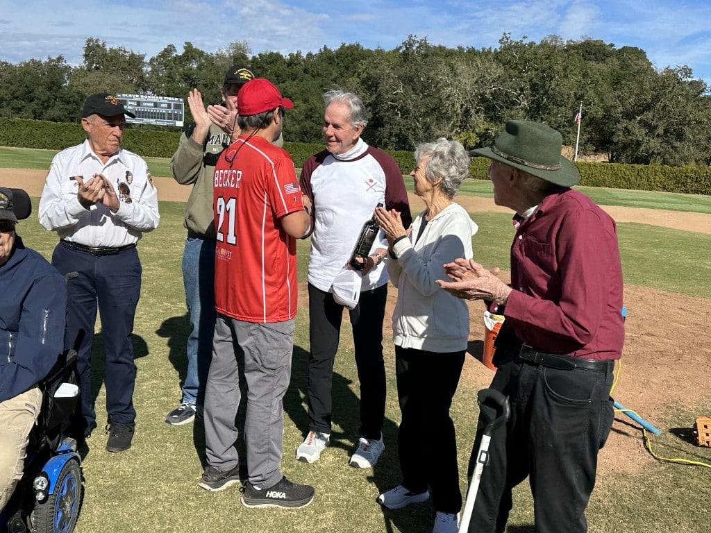 Chef Thomas Keller, surrounded by veteran Marines, was presented with a signed bottle of wine on behalf of the Mixed Nutts by Navy Seal special operations veteran Alejandro Becker.